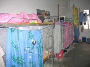 This dormitory room at the Tat Fat Shoe Factory in Dongguan, China, is typical of the accommodations provided to migrant workers. The workers in the factory are from various parts of China with different dialects, but here they speak Mandarin to communicate with each other. One common goal has brought them together far from their families -- the piecework they do every day provides them a livelihood to send money back home. For possible use with globalfaces-china-factory moved on April 29, 2004. (UPI Photo/Yan Tai)